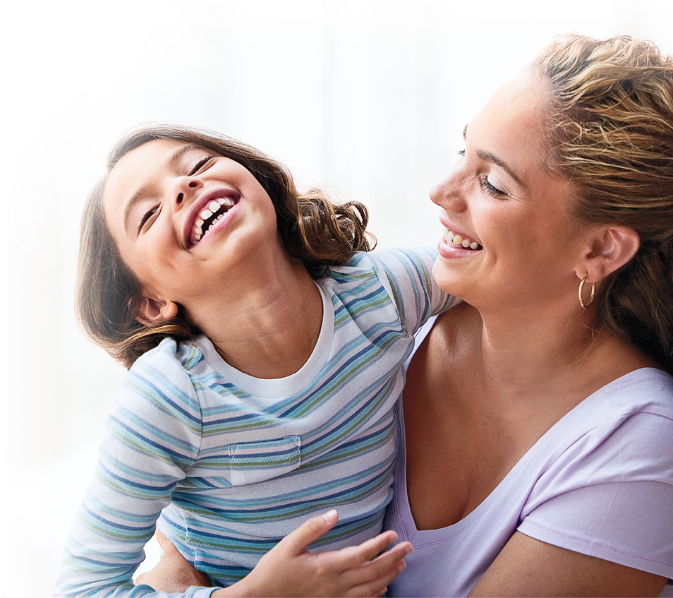 A mother and daughter laughing together in perfect health.